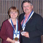 Two AVDC Presidental Medal of Stewardship winners stand holding their medals