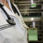 veterinarian in white coat with stethoscope