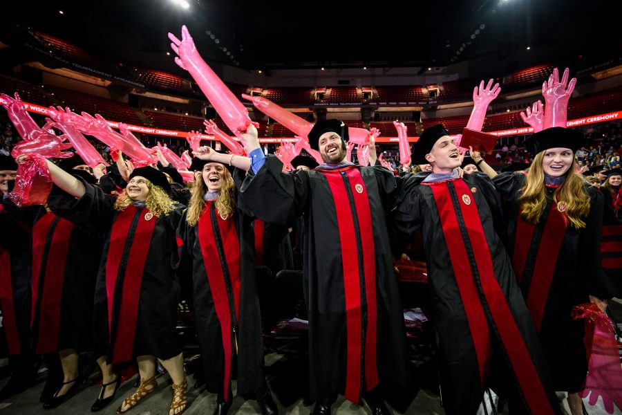 Graduates from the School of Veterinary Medicine celebrate sing Varsity while holding inflated red medical gloves during UW-Madison's spring commencement ceremony at the Kohl Center at the University of Wisconsin-Madison on May 10, 2019. The indoor graduation was attended by over 900 doctoral, MFA and medical student degree candidates, plus their guests