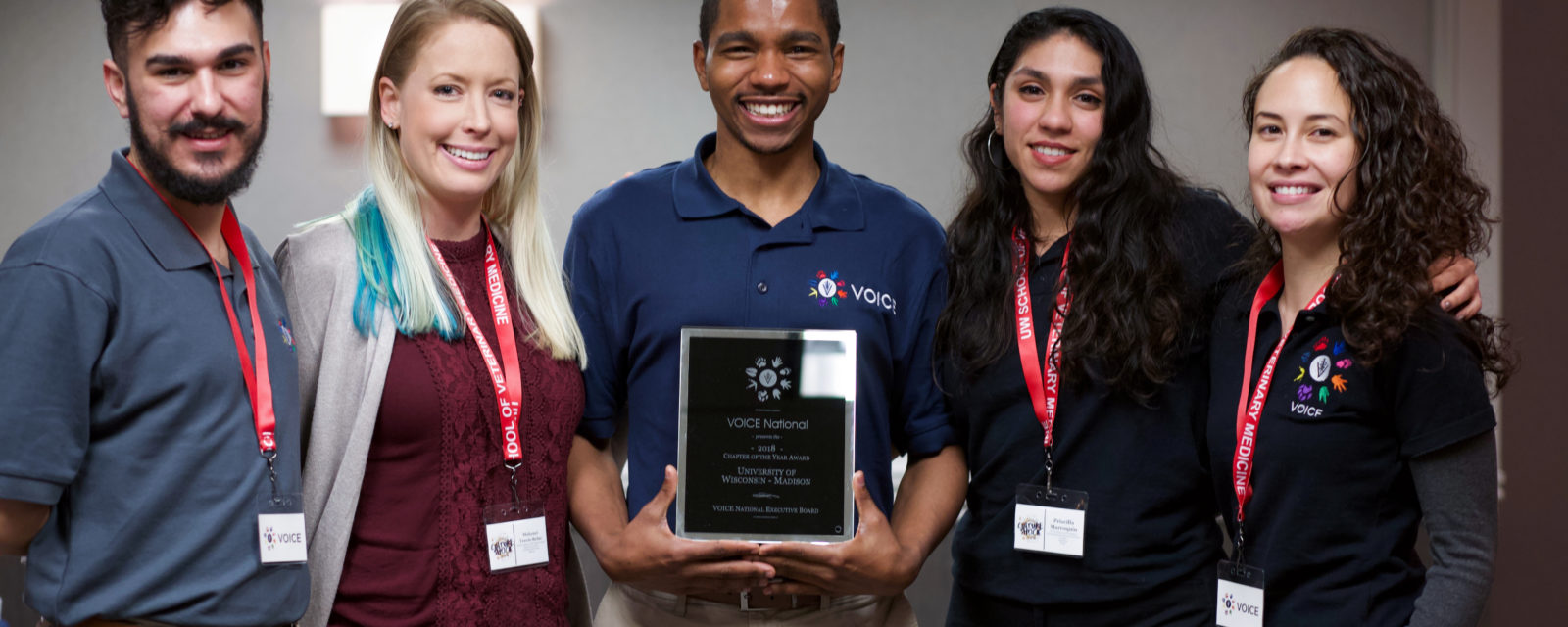 Officers of the UW SVM chapter of Veterinarians as One Inclusive Community for Empowerment (VOICE) accept the 2018-19 VOICE National Chapter of the Year Award. From left to right: Kameron Montana DVMx’20, Makenzi Travis-Balac DVMx’20, Kyle Granger DVMx’20, Priscilla Marroquin DVMx’21 and Jessica Carag DVMx’20. Not pictured: Melissa Sheth DVMx’21 and Clara Cole DVMx’21