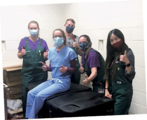 Veterinary medical students and UW Veterinary Care staff pose with gratitude with the new hay steamer from Mary and Jeffrey Brown